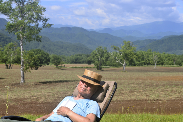 Solo camping image, senior man taking a nap