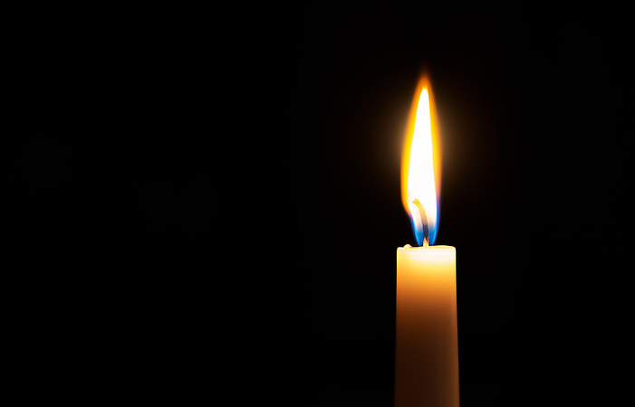 Single lit candle with quite flame on black background Single lit candle with quite flame on black background, by Zoonar Svetlana Sult