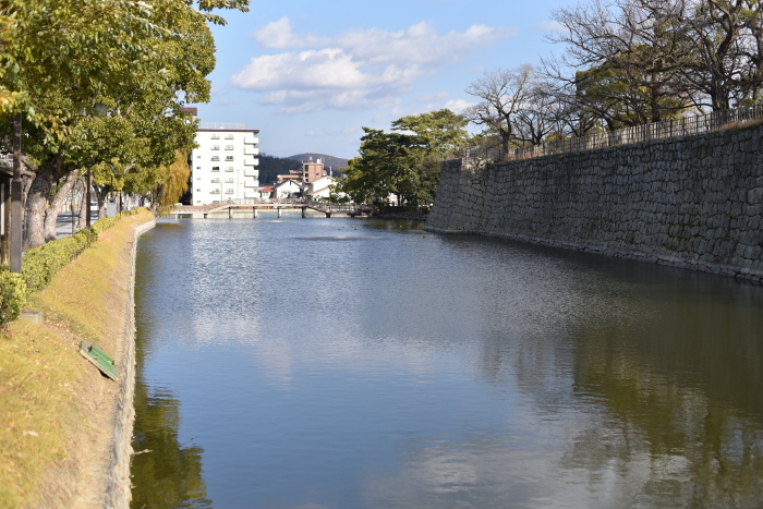 Stone wall reflected in the moat of Marugame Castle