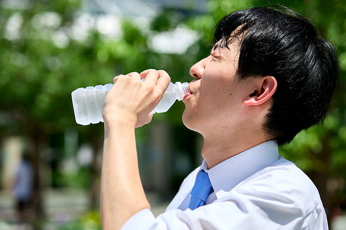 Japanese businessman drinking bottled water