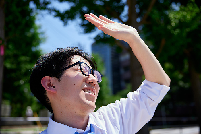 Japanese businessman holding up his hand