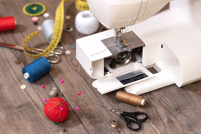 Seamstress or tailor background with sewing tools, colorful threads, sewing machine and accesories . Seamstress or tailor background with sewing tools, colorful threads, sewing machine and accesories .