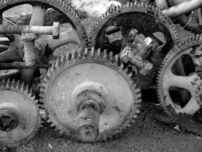 monochrome image of old rusting cogwheels with broken teeth and bolts monochrome image of old rusting cogwheels with broken teeth and bolts