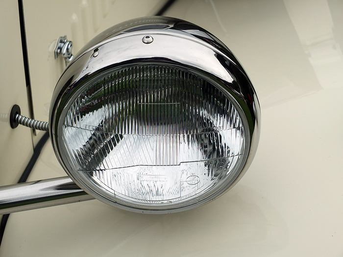 silver car headlamp on a white vintage automobile silver car headlamp on a white vintage automobile