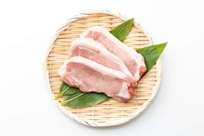 Pork loin on white background (overhead shot)