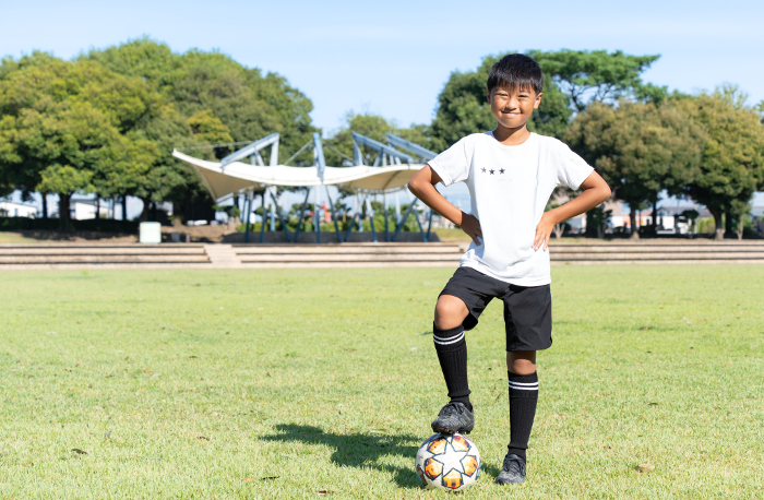 Elementary school boy practicing soccer
