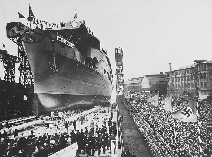 Graf Zeppelin aircraft carrier launch, Kiel, Germany, 1938 Graf Zeppelin just after launch from the Deutsche Werke shipyard in Kiel, Germany, 1938. Construction on the German aircraft carrier began in 1936 when her keel  main structural element  was laid down. Named in honour of Graf  Count  Ferdinand von Zeppelin, the ship was launched on 8 December 1938. By the time World War II broke out in September 1939, the ship was 85  complete. Ultimately, construction was never completed due to shifting construction priorities from the war. The ship would have carried a complement of 42 fighter aircrafts and dive bombers. The ship remained in the Baltic for the duration of the war and was eventually sunk as a target ship by the Soviet Navy in 1947., by US NAVY SCIENCE PHOTO LIBRARY