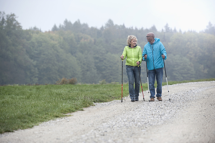 senior couple enjoys nordic walking,health,sport,environmental consciousness Senior couple hiking with hiking poles, Bavaria, Germany