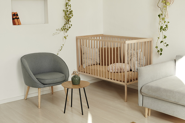 Furniture and baby crib in living room at home