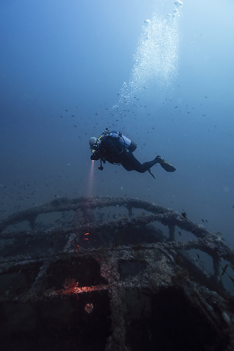 Man examining sunken ship El Naranjito undersea