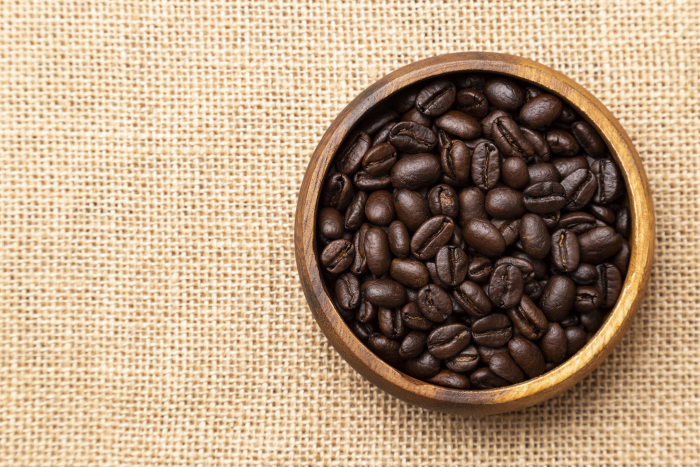 Coffee beans on linen (overhead shot)