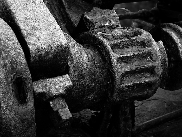 monochrome image of rusted cogs and gears on an old abandoned broken industrial machinery monochrome image of rusted cogs and gears on an old abandoned broken industrial machinery