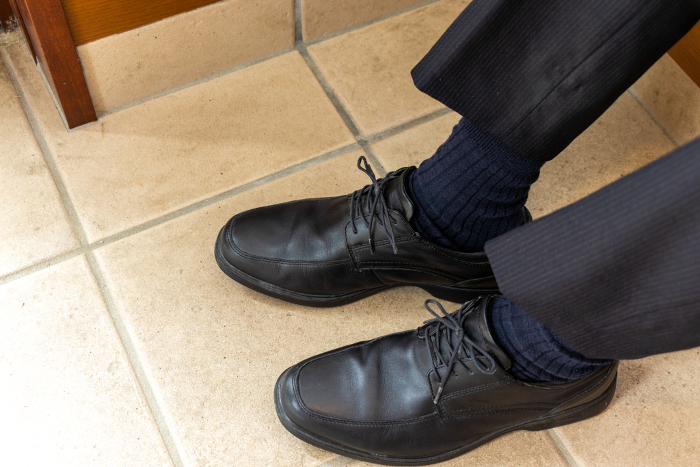 Man's feet in black leather shoes