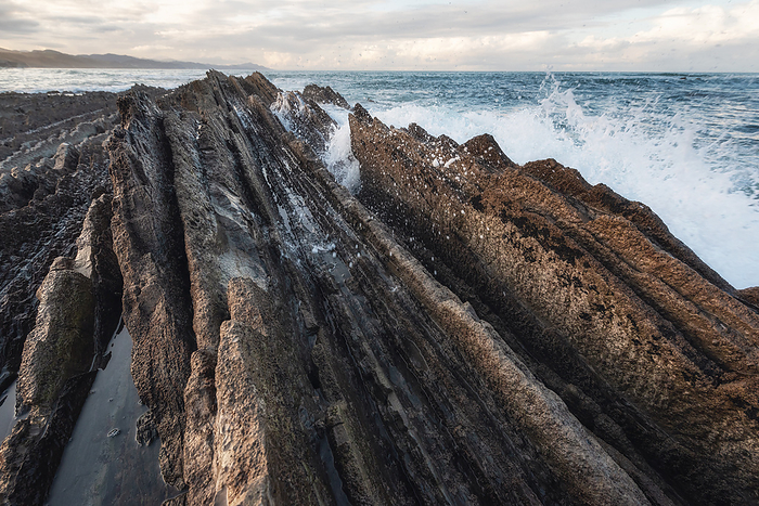 Coast landscape of famous Flysch in Zumaia, Basque country, Spain. Famous geological formations landmark. Coast landscape of famous Flysch in Zumaia, Basque country, Spain. Famous geological formations landmark.