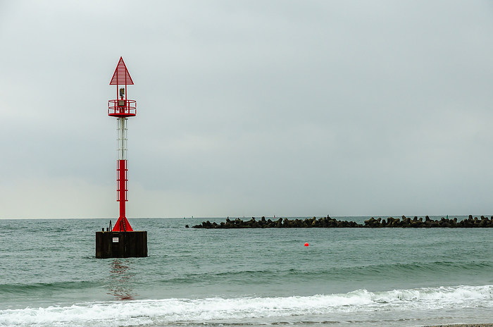 Warning Light for Shipping Standing in Water, Helgoland, North Sea, Germany Warning Light for Shipping Standing in Water, Helgoland, North Sea, Germany