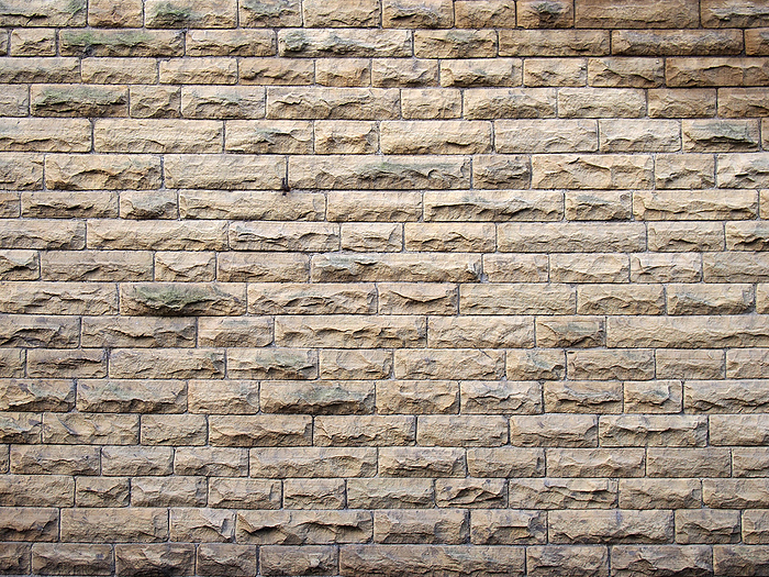 a full frame image of an old yellow sandstone wall made of regular blocks a full frame image of an old yellow sandstone wall made of regular blocks