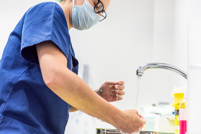 Coronavirus prevention. Nurse washing her hands after treat a patient with Covid 19 infection. Medical sanitizing procedure. Coronavirus prevention. Nurse washing her hands after treat a patient with Covid 19 infection. Medical sanitizing procedure.