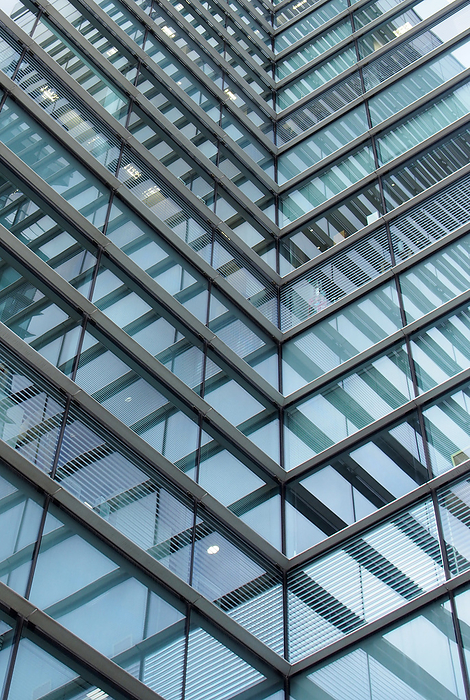 a full frame modern office architecture abstract with geometric angular reflected shapes and lines in blue glass windows a full frame modern office architecture abstract with geometric angular reflected shapes and lines in blue glass windows