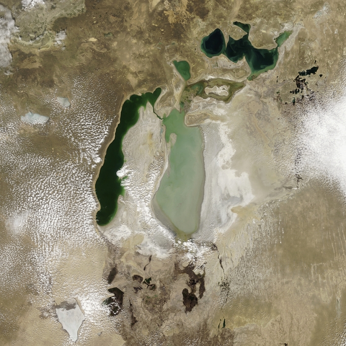 Aral Sea  April 15, 2007  Aral Sea, 2007. Satellite image of the Aral Sea  green . Sediment  pale green , vegetation  dark green  and dry salt beds  white  left by evaporating water can be seen. This inland lake is found between Uzbekistan and Kazakhstan and used to be the fourth largest lake in the world. By 2005 it had shrunk to be only the eighth largest and at the time it was predicted that it would disappear by 2020. In August 2005, the Dike Kokaral dam was built to separate the small North Aral Sea  upper right  from the large South Aral Sea  centre  to prevent further shrinking. By 2007, the dam had led to a growth in the North Aral Sea, but not in the South Aral Sea. Image taken on 15th April 2007 by the MODIS camera on NASA s Terra satellite. See E590 249 for the Aral Sea in 2005.