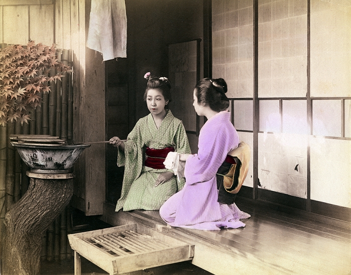 Woman in Kimono  1890s  A woman in kimono uses a Hishaku  ladle  to splash water over the hands of another woman who is washing her hands. The two woman are sitting on the porch of a private house. Washing hands  Temizu  is an important purification ritual when entering shinto shrine grounds, but was also done upon entering a private home. Meiji 1890s