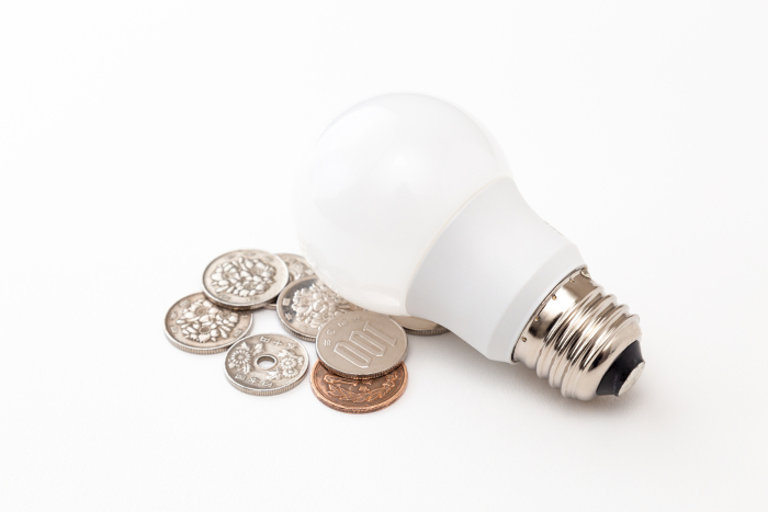White background with pennies and LED bulbs