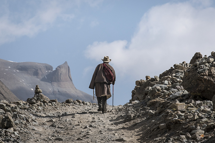 Pilgrim starting on the Kora pilgrimage at Mount Kailash; Tibetan Autonomous Region, Tibet, by Christopher Roche / Design Pics