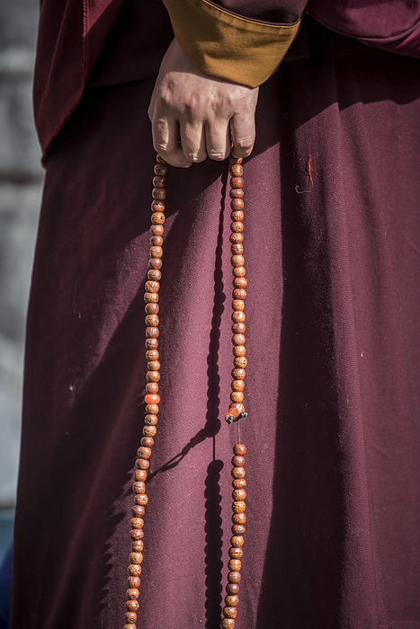 Pilgrim in Lhasa with prayer beads; Lhasa, Tibetan Autonomous Region, Tibet, by Christopher Roche / Design Pics