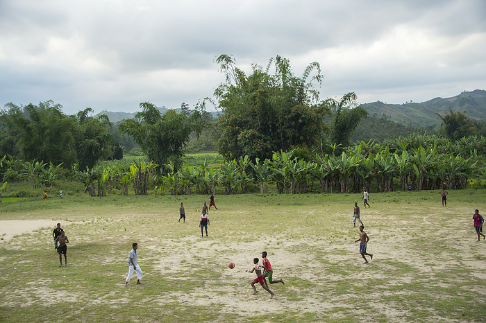 Group of young men and teenagers play soccer in Madagascar; Andasibe, Madagascar, by Joel Sartore Photography / Design Pics