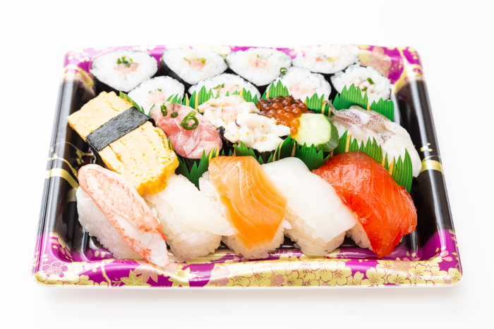 Packed sushi on white background