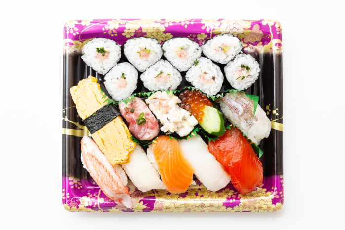 Packed sushi on white background (overhead shot)
