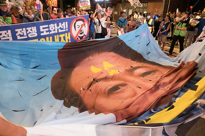 South Koreans protest Japan s release of radioactive water from the crippled Fukushima nuclear power plant Protest against Japan and Yoon Suk Yeol, Aug 26, 2023 : People unfold a portrait of South Korean President Yoon Suk Yeol, disgraced with nuclear symbols, to tear in front of the Japanese embassy in Korea during a rally to protest Japan s release of radioactive water from the crippled Fukushima nuclear power plant and to denounce South Korean President Yoon in Seoul, South Korea. Thousands of people attended the protest and asked for resignation of President Yoon who they insist, strings along with Japan s release of radioactive water. The Korean letters on placard read, Let s oust Yoon Suk Yeol from the presidency who is a traitor to Korea and cause of war  . Pickets read, Yoon Suk Yeol Resign  .  Photo by Lee Jae Won AFLO   SOUTH KOREA 