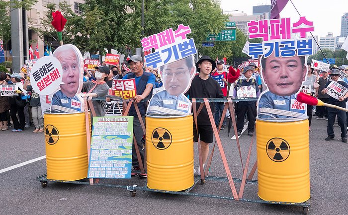 South Koreans protest Japan s release of radioactive water from the crippled Fukushima nuclear power plant Protest against Japan and Yoon Suk Yeol, Aug 26, 2023 : People march during a rally to protest Japan s release of radioactive water from the crippled Fukushima nuclear power plant and to denounce South Korean President Yoon Suk Yeol in Seoul, South Korea. Thousands of people attended the protest and asked for resignation of President Yoon who they insist, strings along with Japan s release of radioactive water. The Korean letters parodying on cutout portraits of the U.S. President Joe Biden, Japanese Prime Minister Fumio Kishida and South Korean President Yoon  L R  read, The East Sea of Korea is the Sea of Japan  ,  Criminal of dumping nuclear contaminated water  and  Accomplice of dumping nuclear contaminated water .  Photo by Lee Jae Won AFLO   SOUTH KOREA 