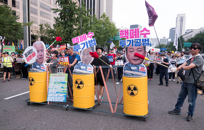 South Koreans protest Japan s release of radioactive water from the crippled Fukushima nuclear power plant Protest against Japan and Yoon Suk Yeol, Aug 26, 2023 : People march during a rally to protest Japan s release of radioactive water from the crippled Fukushima nuclear power plant and to denounce South Korean President Yoon Suk Yeol in Seoul, South Korea. Thousands of people attended the protest and asked for resignation of President Yoon who they insist, strings along with Japan s release of radioactive water. The Korean letters parodying on cutout portraits of the U.S. President Joe Biden, Japanese Prime Minister Fumio Kishida and South Korean President Yoon  L R  read, The East Sea of Korea is the Sea of Japan  ,  Criminal of dumping nuclear contaminated water  and  Accomplice of dumping nuclear contaminated water .  Photo by Lee Jae Won AFLO   SOUTH KOREA 