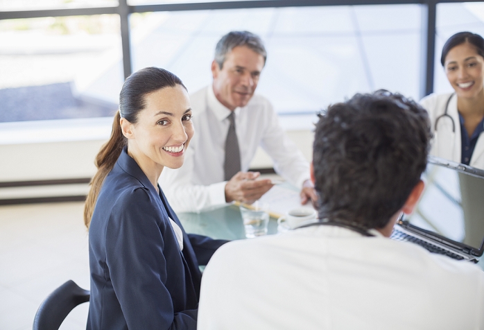 Business people in a meeting Businesswoman smiling in meeting