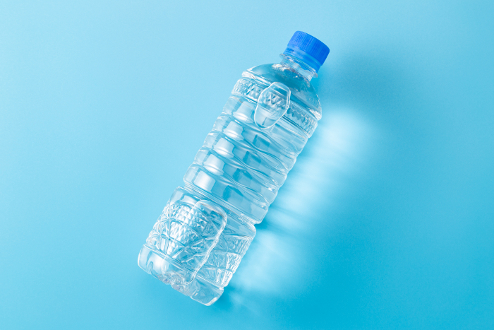 Bottled drinking water on blue background