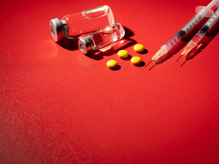 Yellow Pill and Vial Red Background