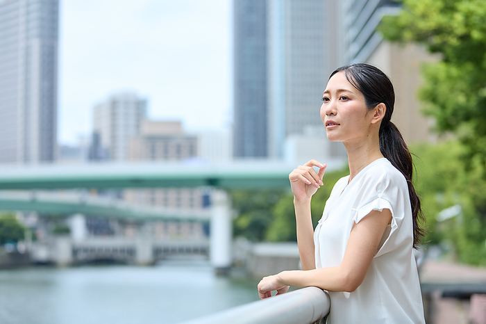 Japanese woman leaning against the railing