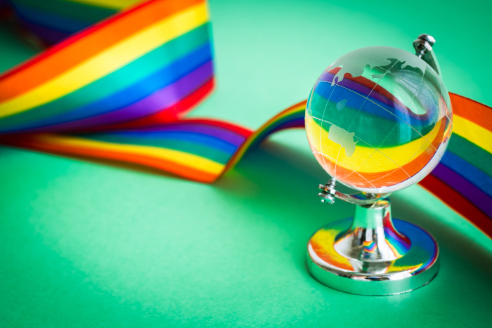 Globe and rainbow-colored ribbon