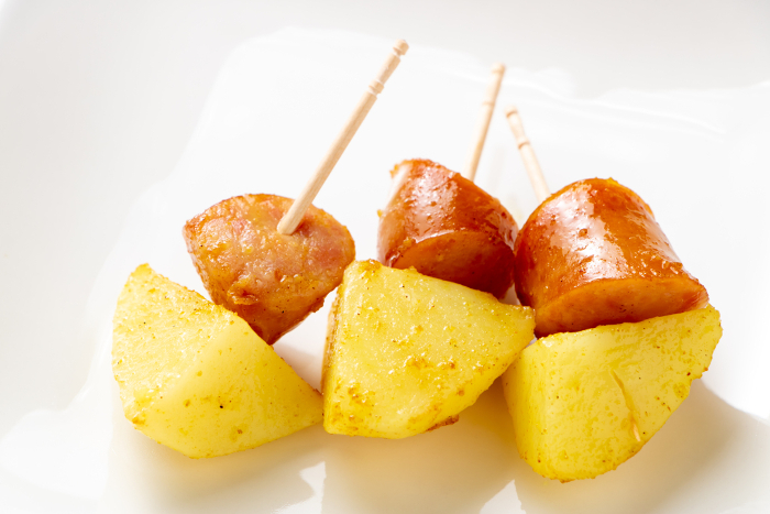 Sauteed potatoes and sausage with curry. (Toothpick sticks.)
