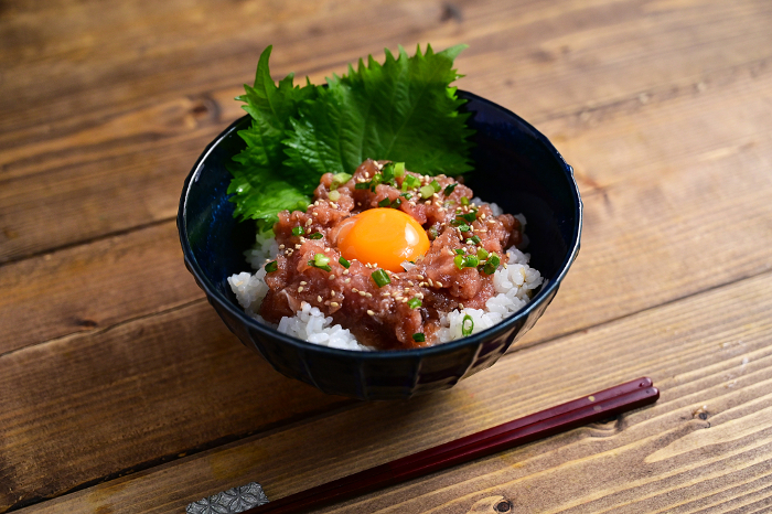 bowl of rice topped with pickled negitoro (onion and tuna)