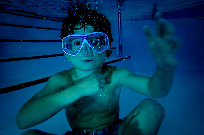 Underwater portrait of a boy wearing a mask