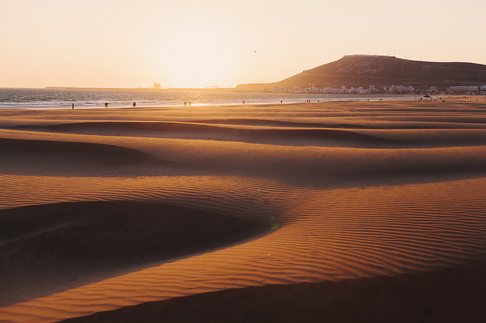 The sunset on a sandy beach in Agadir, Morocco.
