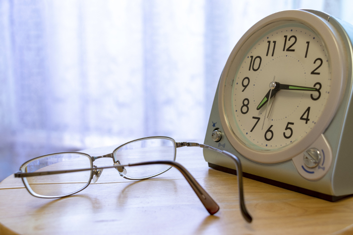 Clock and glasses on the table