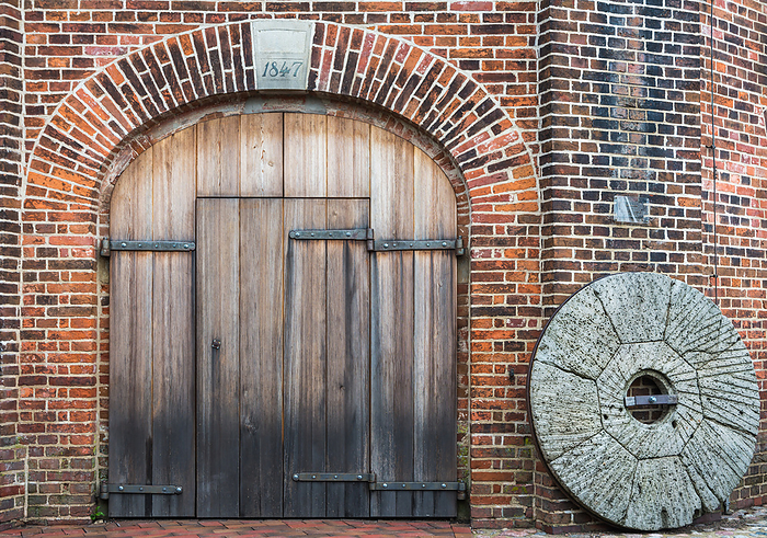 Wooden Door and old millstone, Jever Windmill, Friesland, Lower Saxony, Germany Wooden Door and Old Millstone, Jever Windmill, Friesland, Lower Saxony, Germany, by Zoonar Conny Pokorny