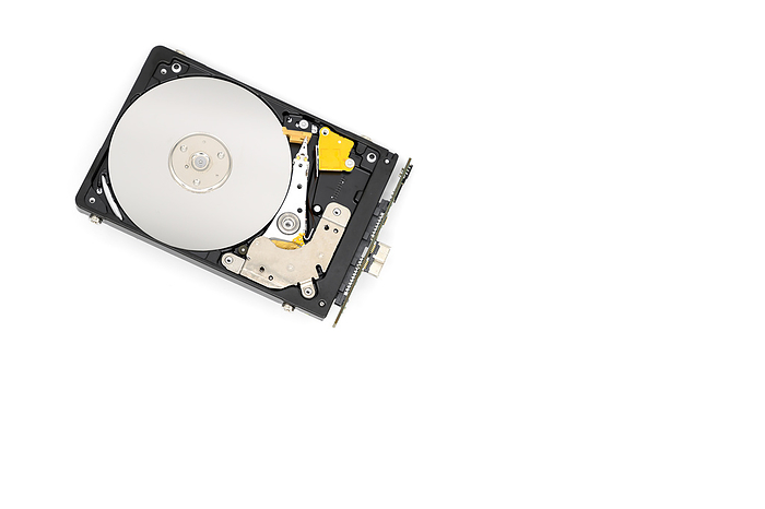 Disassambled Hard disk drive isolated on white background. Disassambled Hard Disk Drive Isolated on White Background., by Zoonar DAVID HERRAEZ