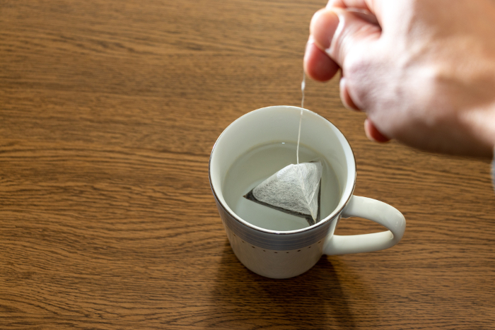 Soak the tea bag in a cup of hot water