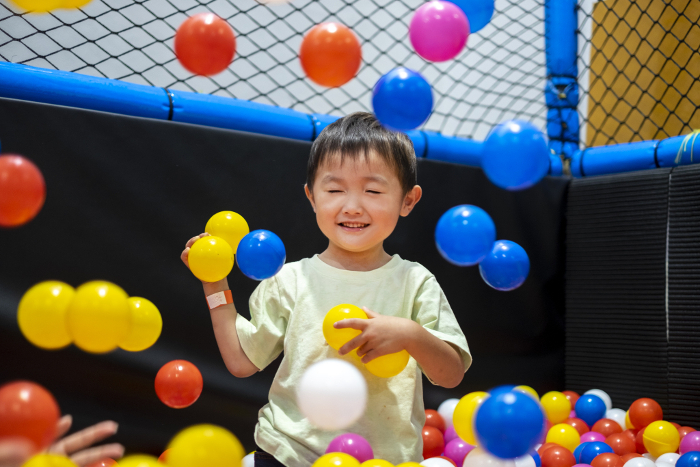 Four-year-old playing in the ball pool