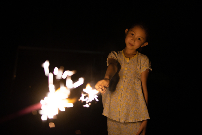 Children enjoying hand-held fireworks