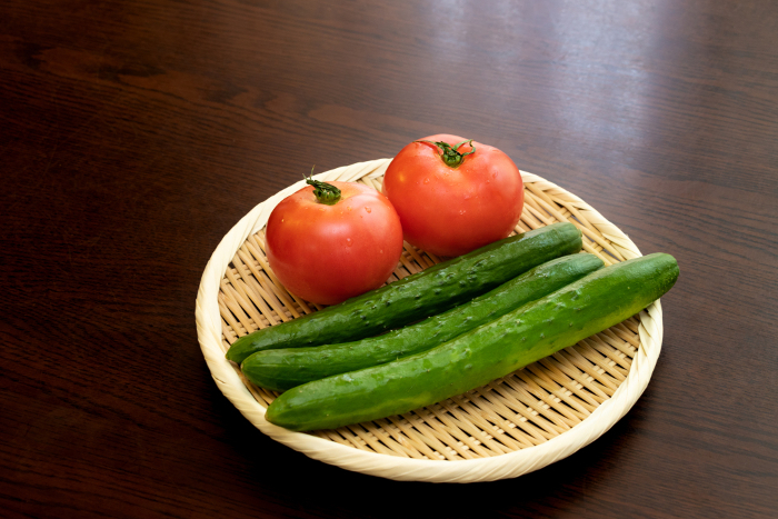 Tomatoes and cucumbers on a bamboo colander