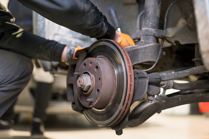 Car mechanic repair brake pads close up. Car Mechanic Repair Brake Pads Close Up., by Zoonar DAVID HERRAEZ